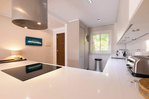 Sleek, modern kitchen with ample space, stylish decor, and natural light—perfect for preparing meals and gathering.







