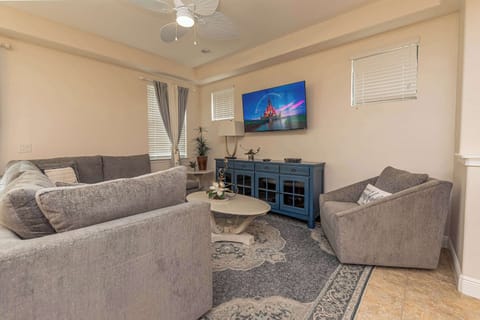 Loads of plush seating and a large wall-mounted Smart TV.