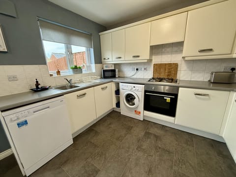 Kitchen: Bright and modern space with sleek appliances, perfect for your culinary adventures!