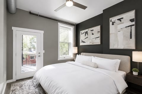 The final bedroom offers a plush king bed as well as balcony & laundry access