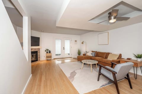 Cozy and spacious living area with TV and fireplace