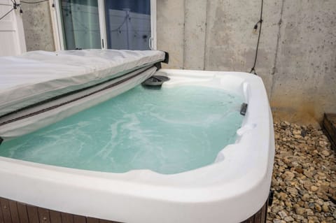 Soak under the stars in a private hot tub oasis ✨🛁 Surrounded by string lights and a cozy privacy fence, it’s the perfect place to unwind and relax!