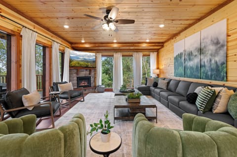 Cozy living room with fireplace and large TV, perfect for relaxing.