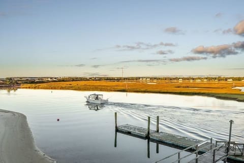 Unwind by the tranquil waterfront, watching boats glide past