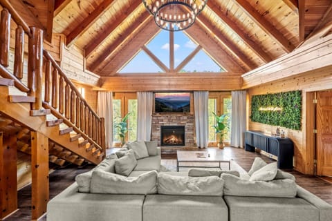 Spacious open-concept living room featuring vaulted ceilings, with Smoky views