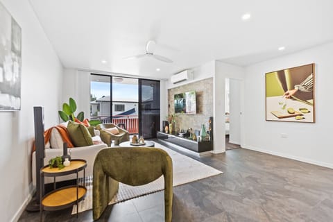 Lounge Room: Bright open space with stylish decor, plush seating, and a sunny balcony for relaxation.