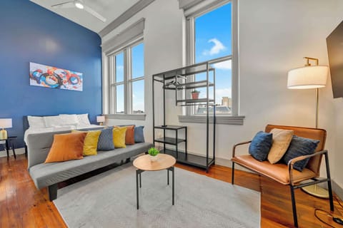Living Room: Bright and open living area with high ceilings, comfortable seating, and stylish decor—ideal for relaxing or entertaining.