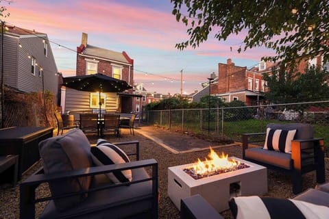 Cozy backyard with fireplace, barbecue, dining area and bar