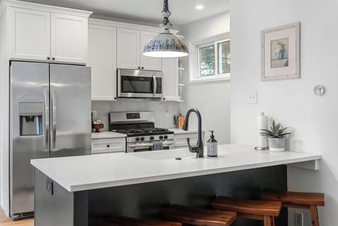 The chic kitchen offers ample space & all the comforts of home