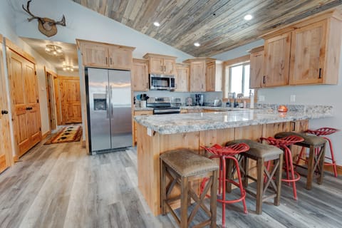 Spacious kitchen with large island and bar seating, perfect for gathering.