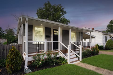 Enjoy a welcoming porch surrounded by beautiful gardens in Evansville's heart.