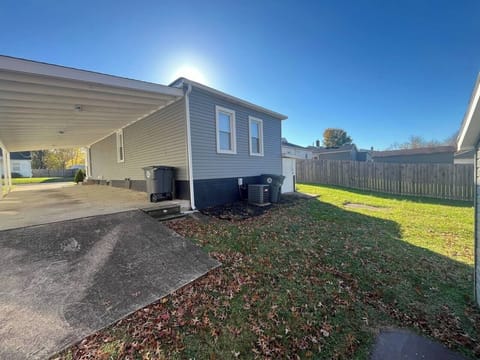 Enjoy a spacious yard perfect for gatherings and shaded parking in Evansville.