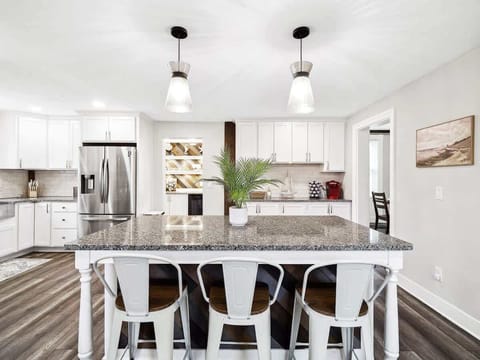 ✨ Whip up your favorite meals in this stunning, fully stocked kitchen featuring granite countertops, stainless steel appliances, and a spacious island perfect for gathering!