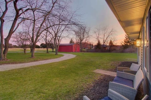 Enjoy quiet mornings on the covered porch overlooking the spacious green yard