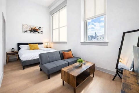 Living Room: Bright and open living area with high ceilings, comfortable seating, and stylish decor—ideal for relaxing or entertaining.
