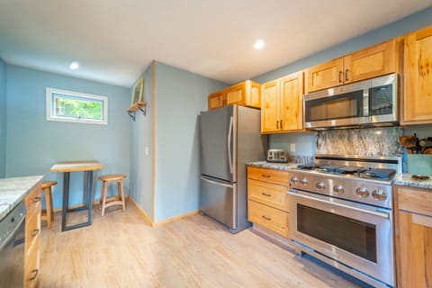 The table at one end of the kitchen is convenient for your computer and remote working. 