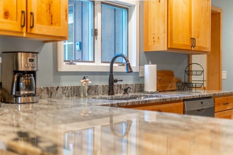 Our stylish kitchen features granite counters and a drip coffee maker. 