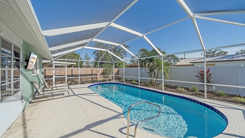 Dive into your fenced, private pool oasis, screened for comfort and surrounded by lush landscaping for the ultimate relaxing Sarasota getaway.