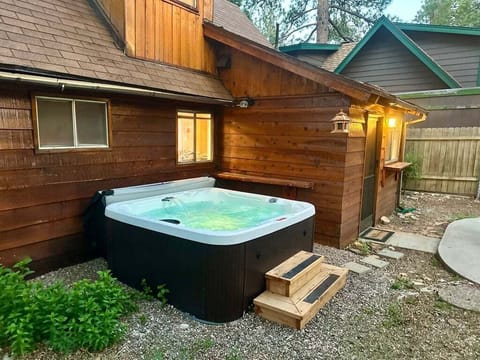 Private outdoor hot tub, surrounded by tall pines, perfect for relaxing under the trees after a day of adventure—enjoy peaceful forest views, fresh air, and a truly rejuvenating stay.