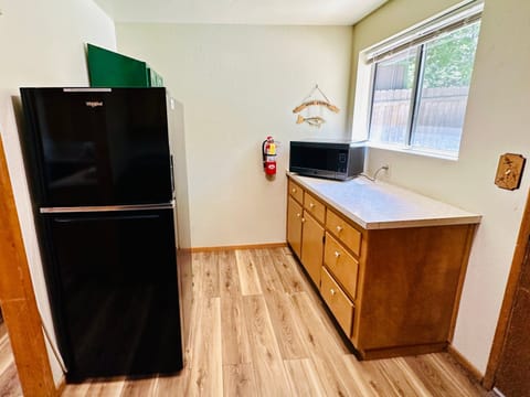 Fully equipped cabin kitchen with ample cabinetry, stove, fridge, and a coffee maker—perfect for cooking meals, morning coffee, and feeling right at home on your stay.