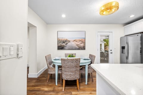 Enjoy meals in the bright and stylish dining area just off the kitchen, offering comfortable seating and a welcoming coastal atmosphere.