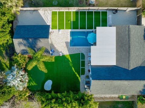Aerial view of your private retreat featuring heated pool, turf sports court, putting green, and resort style outdoor living
