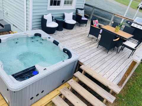7 person hot tub on back deck overlooking fenced in yard