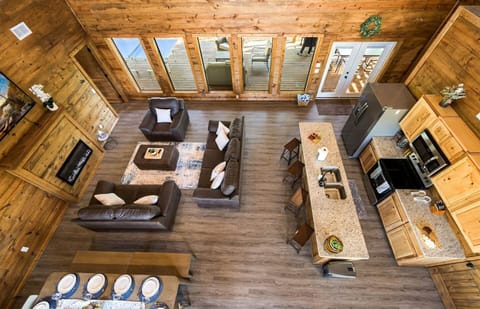 Overview of living room, kitchen, bar table, kitchen table from 2nd floor