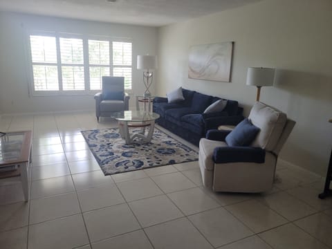 Livingroom with 2 recliners, 78" sofa, and 72" TV.