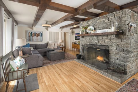 Cozy space with fireplace and beam ceiling.