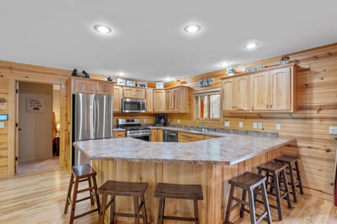 The kitchen is fully equipped and has ample seating right off of the dining area for all to enjoy a family meal together.