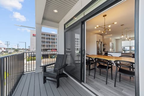 Open concept living room with ocean view, to kitchen, dining, and deck!