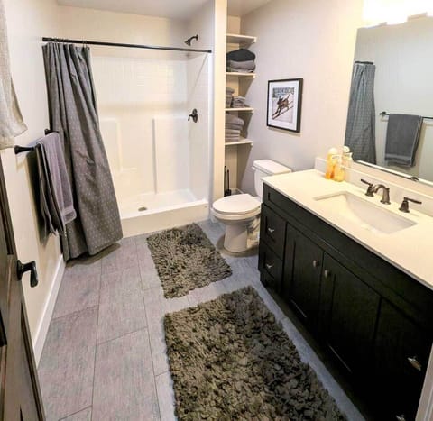 Large stand-up shower in spacious bathroom.