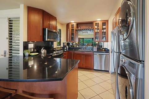 The kitchen has wide counter spaces and stainless steel appliances. – Ideal for preparing meals in style and convenience.