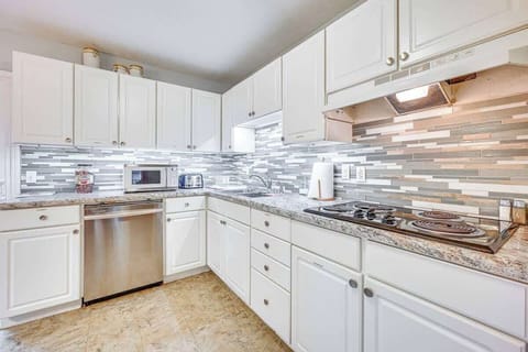 Fully equipped kitchen with bright cabinets and modern touches