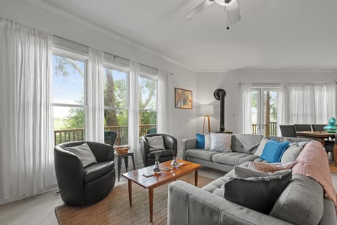 Living Room - Large sectional with two additional chairs and marsh views