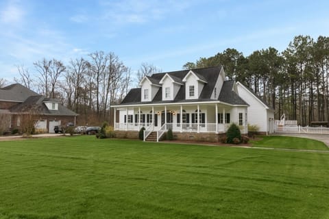 Elegant home with a timeless design and beautiful landscaping.