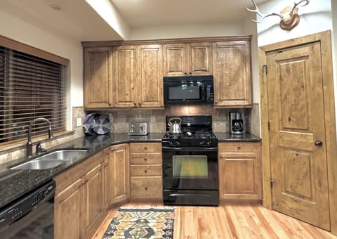 Spacious, well stocked kitchen with gas range, granite counters, pantry & more!