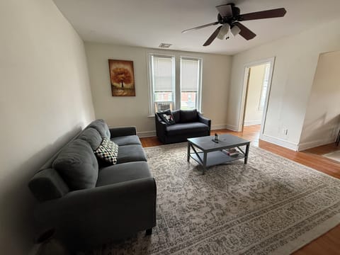 The living room is furnished with all the essentials, including a cozy sofa, coffee table, and TV, offering immediate comfort and a welcoming atmosphere from the moment you move in.