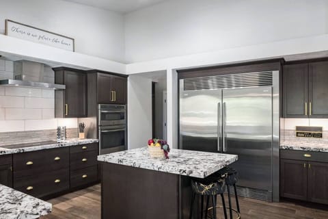 Gourmet kitchen with premium appliances, a commercial-grade fridge, and a large island — ideal for cooking, entertaining, and making memories over great food.