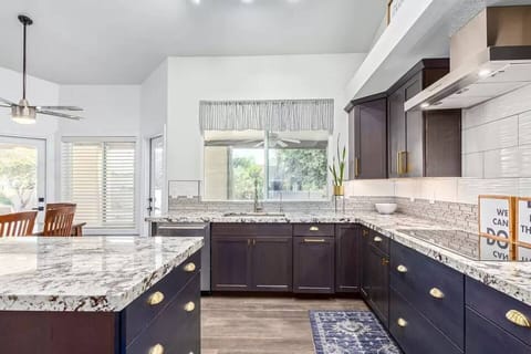 Gourmet kitchen complete with high end appliances, commercial grade refrigerator, large island for cooking and entertaining