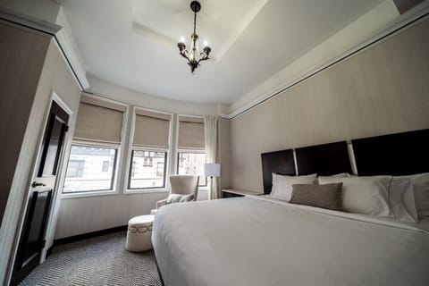 Relax beneath elegant chandelier lighting and calm, cozy décor.