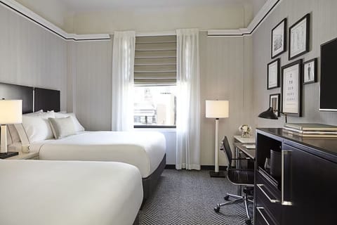 Stretch out in a bright double-queen room with cozy lighting.