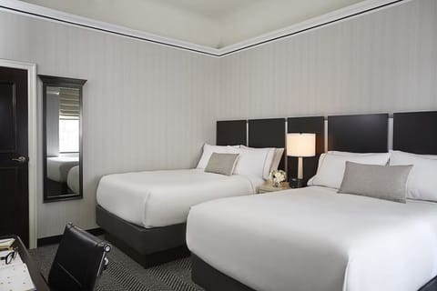 Recharge together in a spacious double-queen room, perfectly made.