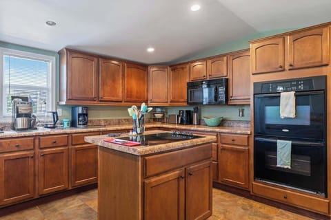 Our kitchen is fully equipped for a great meal, featuring countertop cooking, a double oven, microwave, drip coffee maker, pots, pans, dishes, and plenty of extras.