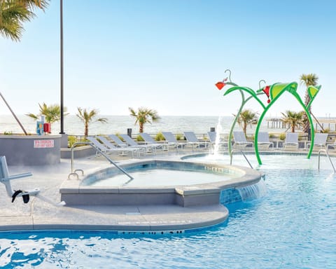 Kids will love the ocean-view water play area, complete with colorful splash features.