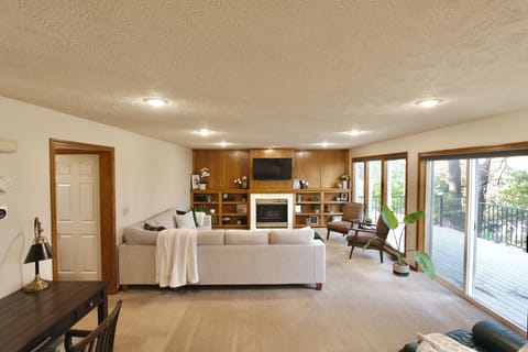 Living room w/ smart TV, convertible movie night sectional & gas fireplace