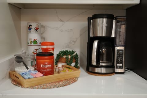 Both kitchens have coffee grounds, filters, sugar and creamer.