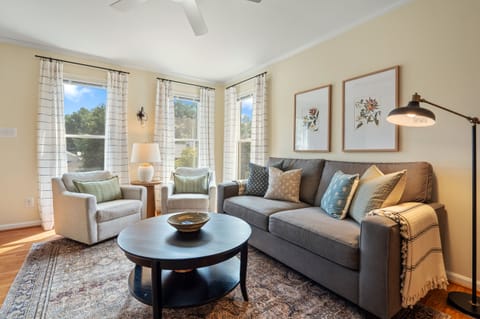 The living room is spacious and filled with natural light. 