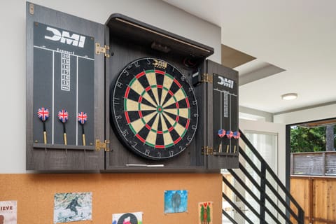Downstairs family room with Queen sleeper sofa, ping pong, streaming TV, games, regulation dart board, mini fridge, wine cooler, access to back yard.